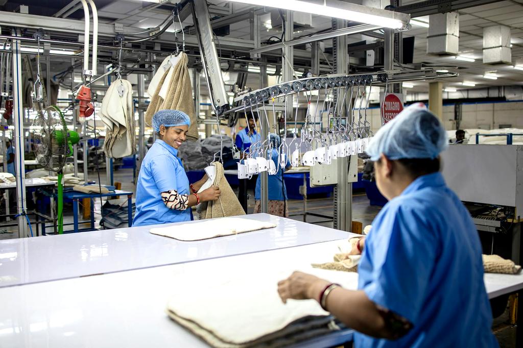 Factory worker interacting with AI automation system